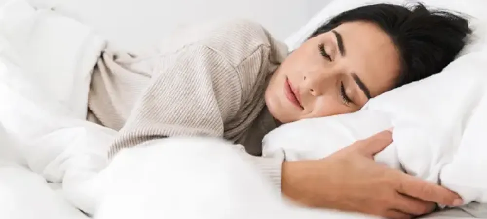 woman sleeping peacefully in bed bug free bed