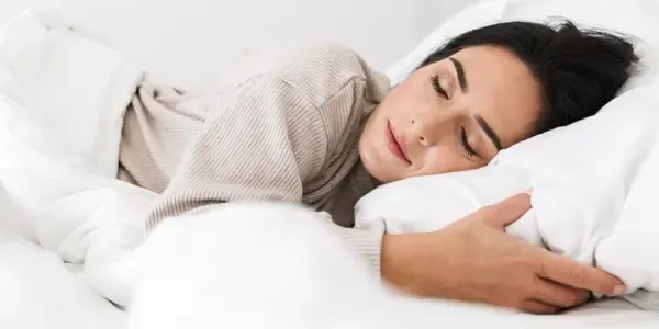 woman sleeping peacefully in bed bug free bed